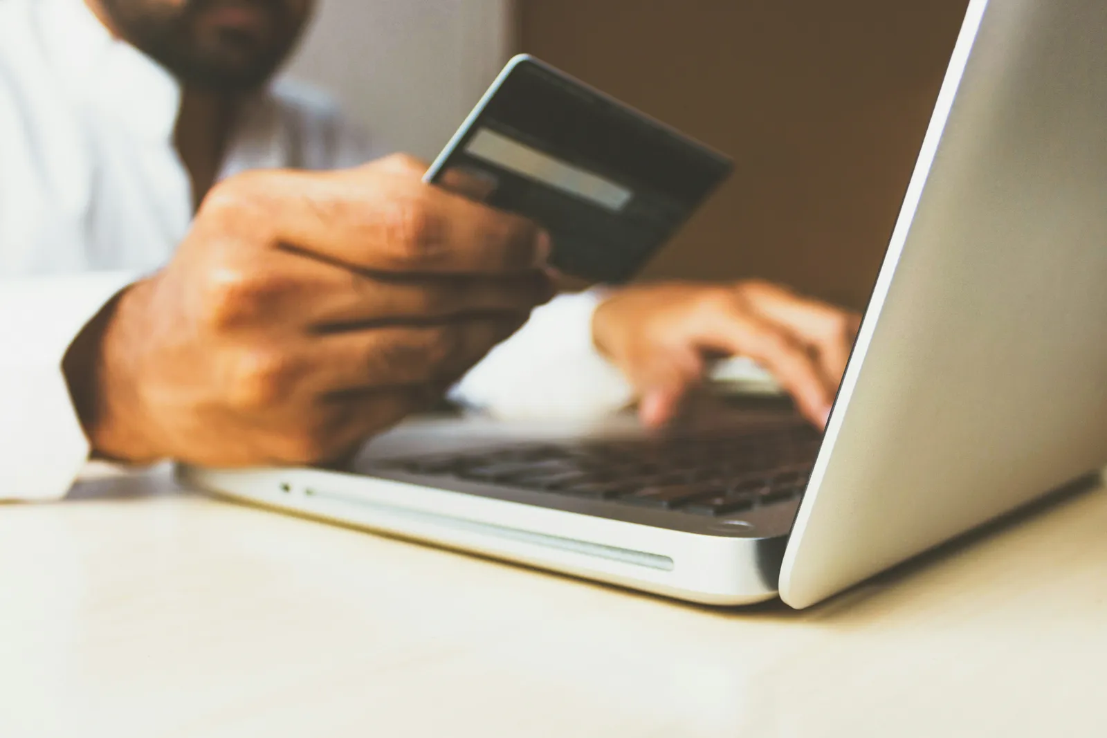 Online shopping checkout with a credit card and laptop