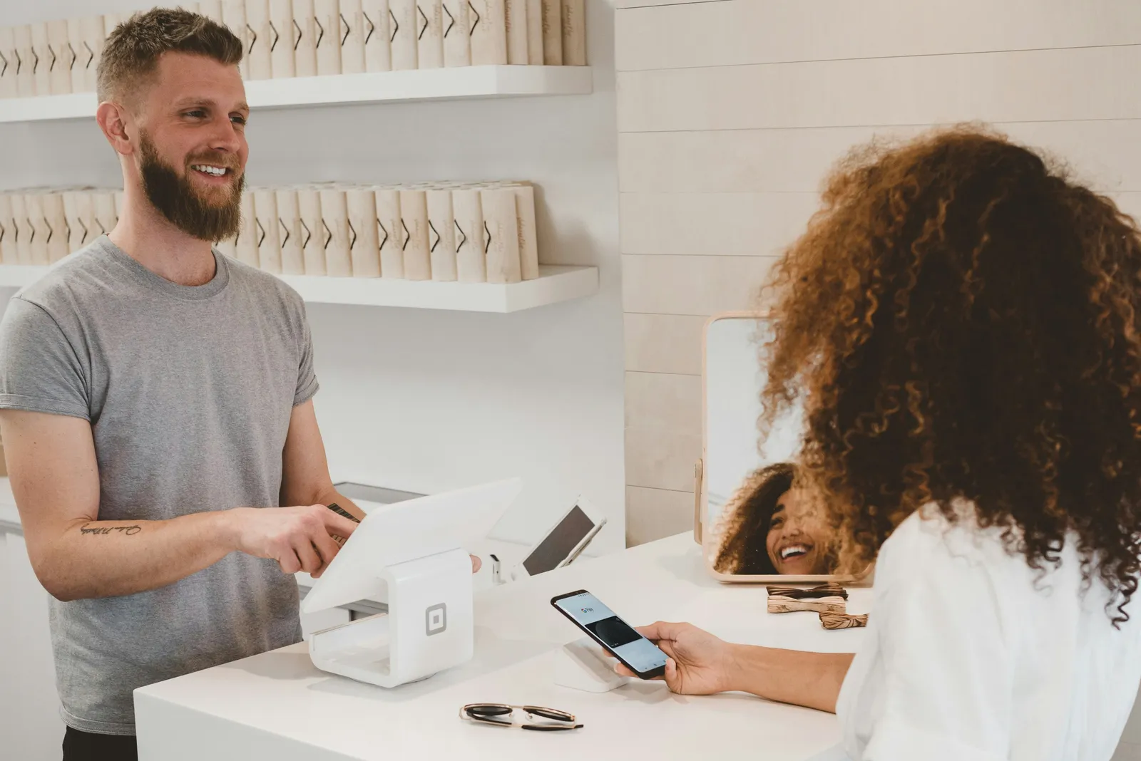 Customer paying at checkout with a contactless card